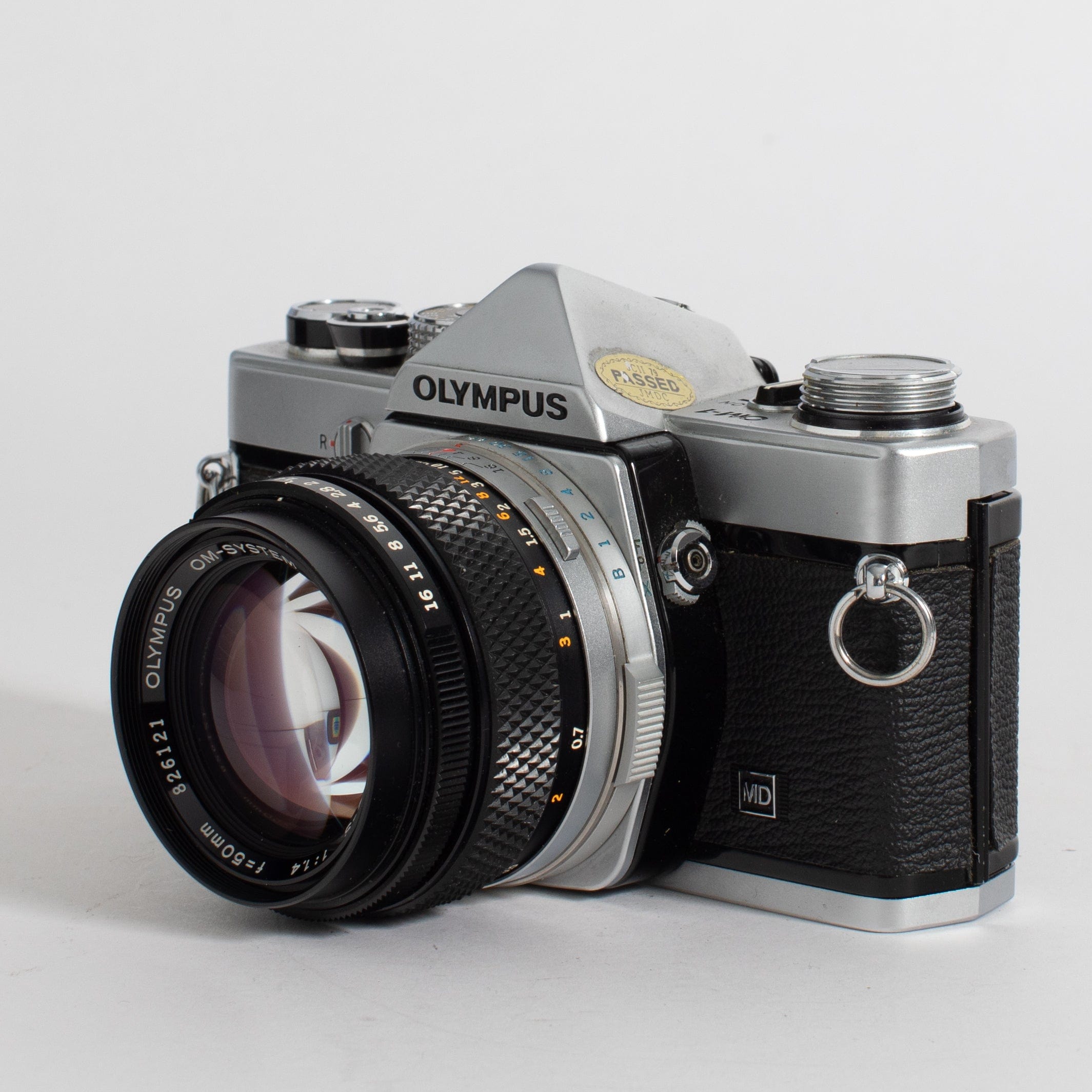 Olympus OM-1 with 50mm f/1.4 lens and leather case (film tested